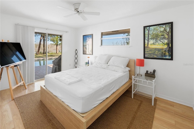 bedroom featuring wood-type flooring, ceiling fan, and access to exterior