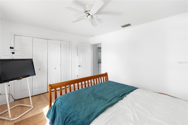 bedroom with a closet, ceiling fan, and light hardwood / wood-style floors