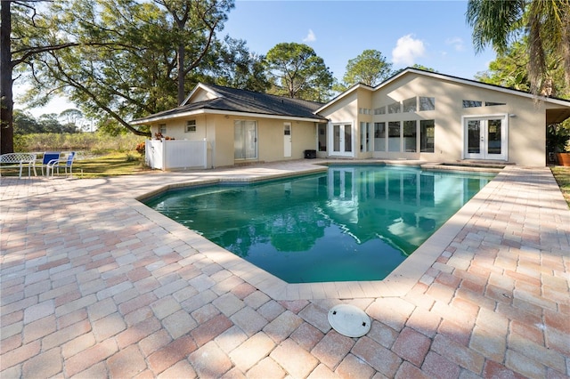 view of swimming pool featuring a patio area and french doors