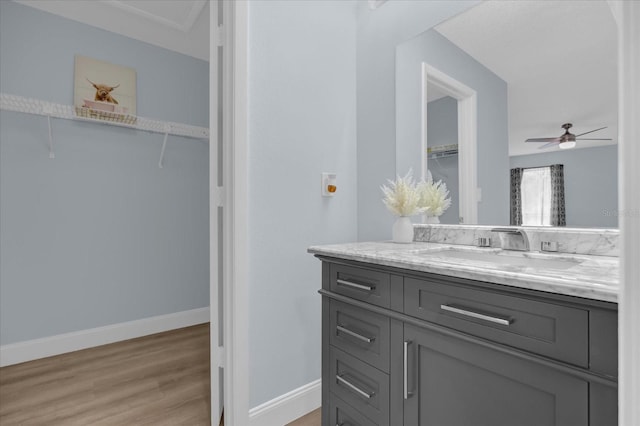 bathroom with vanity, ceiling fan, and hardwood / wood-style flooring