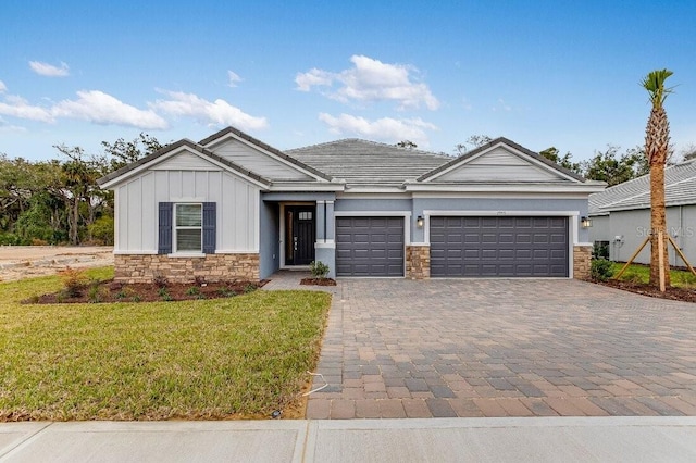 view of front of house with a garage and a front lawn