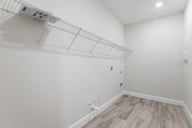 washroom featuring electric dryer hookup, hookup for a washing machine, hookup for a gas dryer, and hardwood / wood-style floors