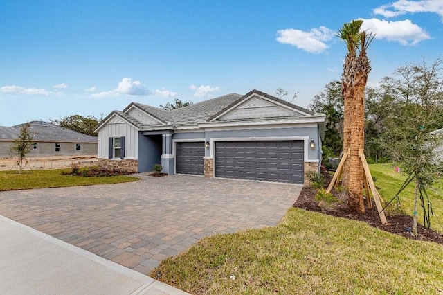 view of front of house with a garage and a front lawn