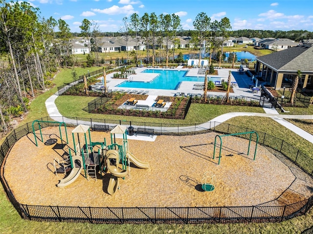 view of pool with a yard and a playground