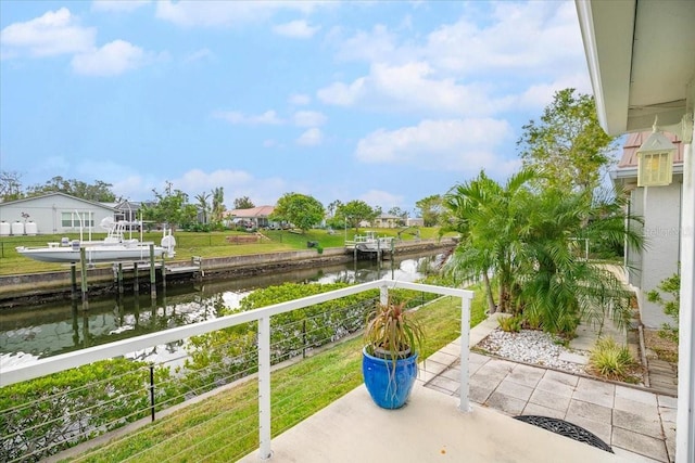 view of patio / terrace featuring a water view and a dock