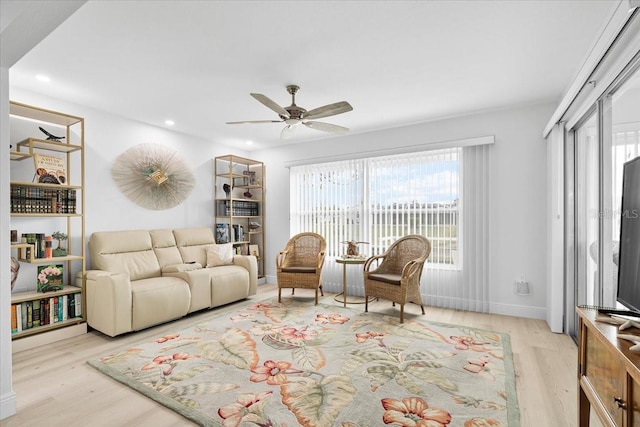 living room with ceiling fan and light wood-type flooring