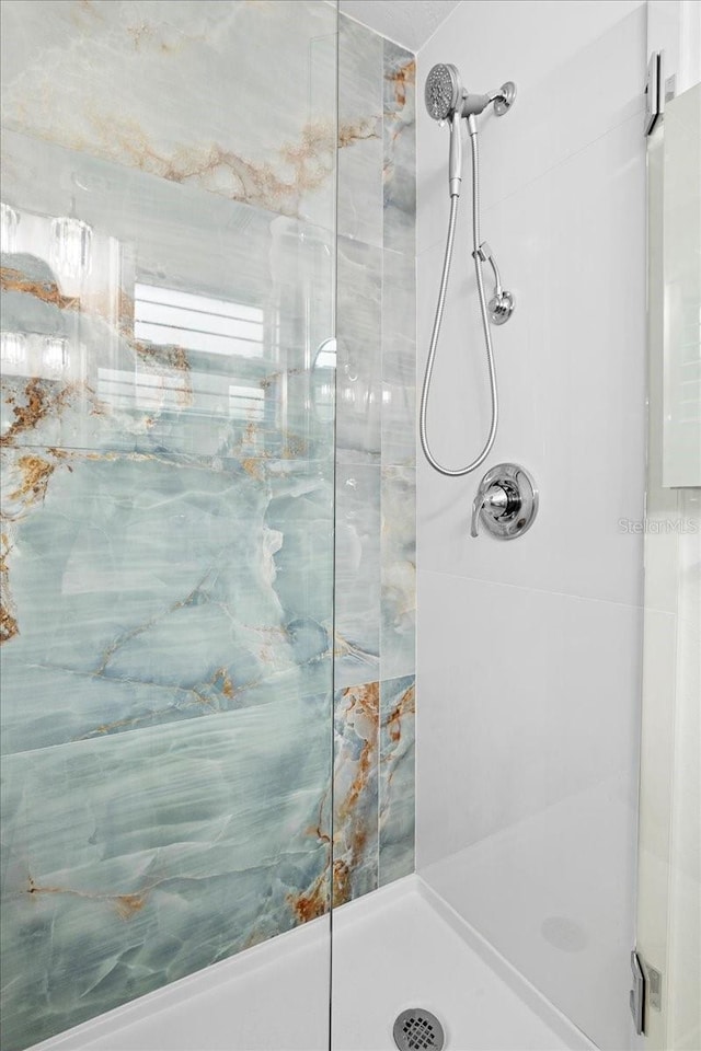 bathroom with a tile shower