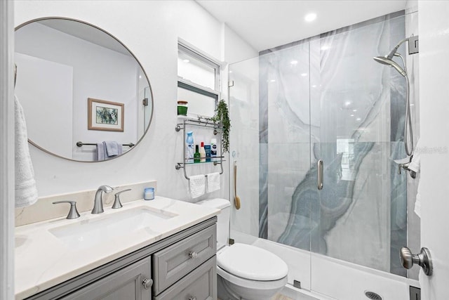 bathroom featuring vanity, toilet, and walk in shower