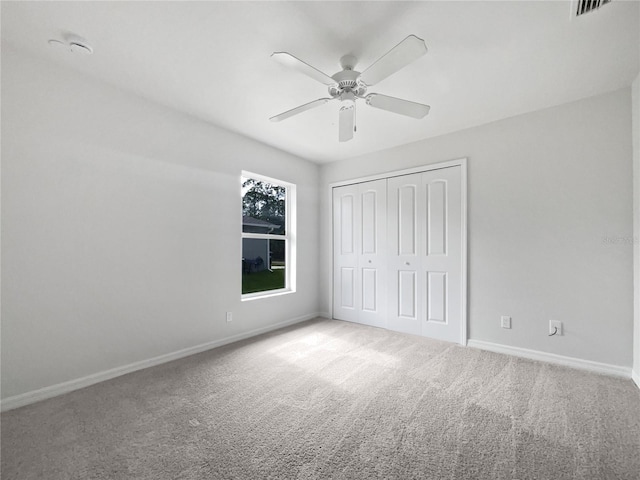 unfurnished bedroom featuring a closet, ceiling fan, and carpet floors