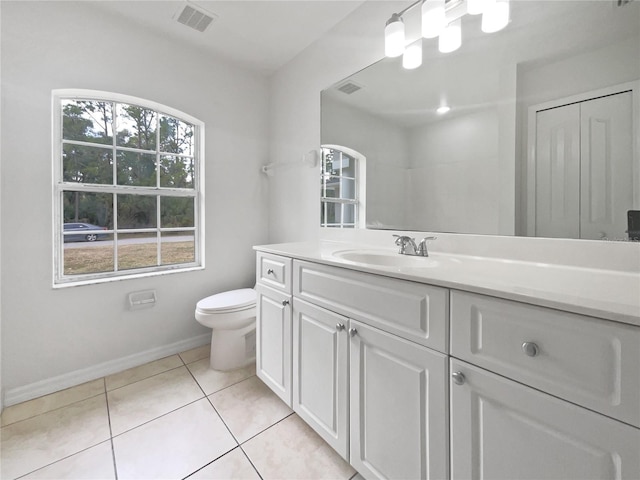 bathroom with toilet, tile patterned flooring, and vanity