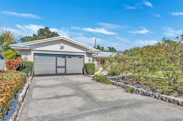 ranch-style home featuring an attached garage and driveway