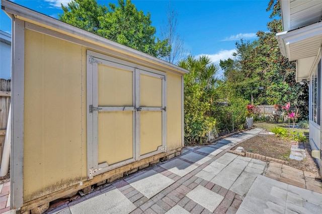 view of shed featuring fence