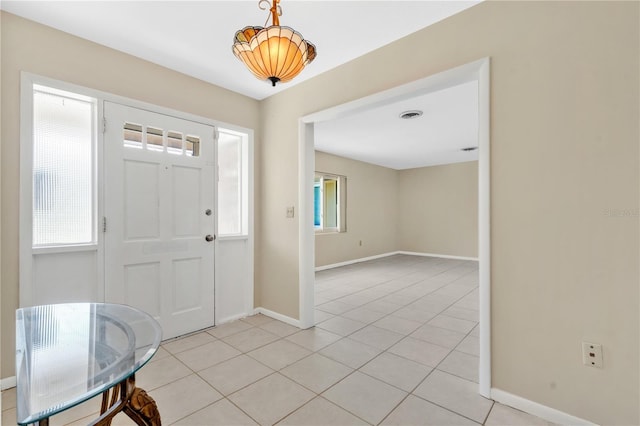 foyer entrance with light tile patterned floors, visible vents, and baseboards