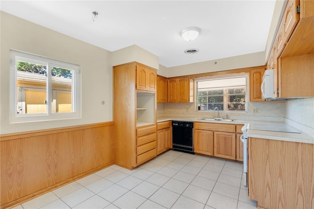 kitchen with visible vents, light countertops, wainscoting, white appliances, and a sink