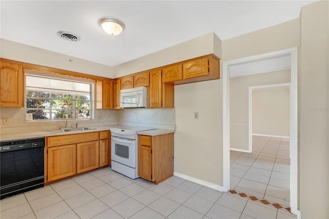 kitchen with visible vents, light countertops, light tile patterned floors, white appliances, and a sink