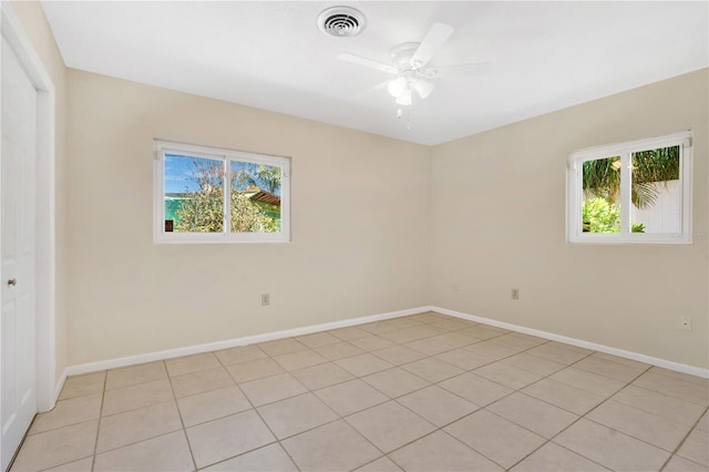 spare room featuring visible vents, baseboards, and ceiling fan