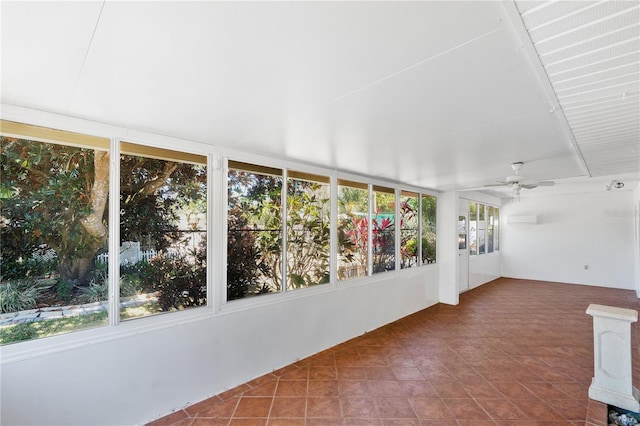 unfurnished sunroom with a healthy amount of sunlight and ceiling fan