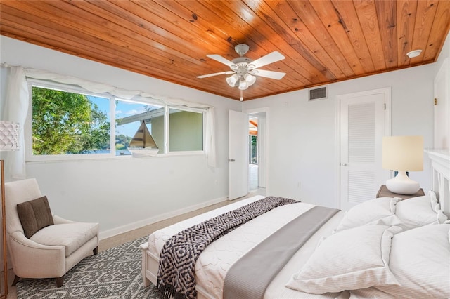 carpeted bedroom with crown molding, ceiling fan, and wooden ceiling