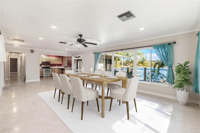 dining space with ornamental molding and ceiling fan