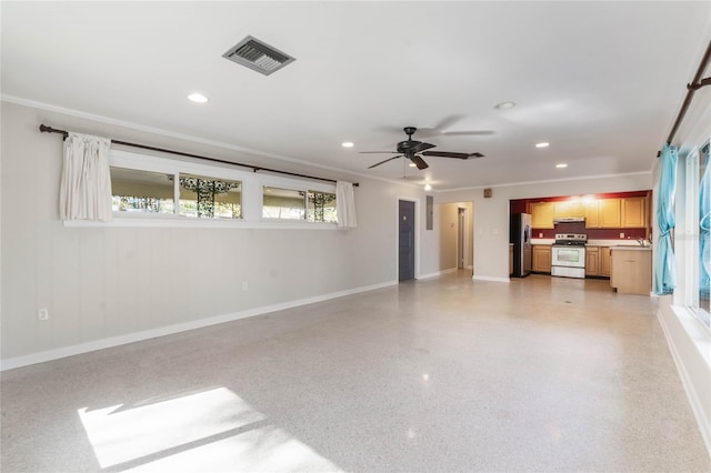 unfurnished living room with crown molding, ceiling fan, and sink