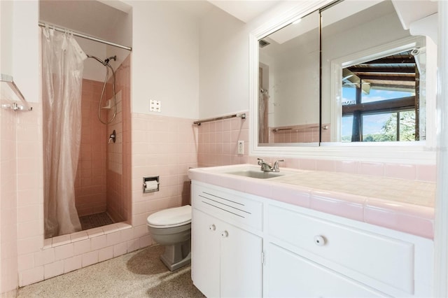 bathroom with walk in shower, vanity, toilet, and tile walls