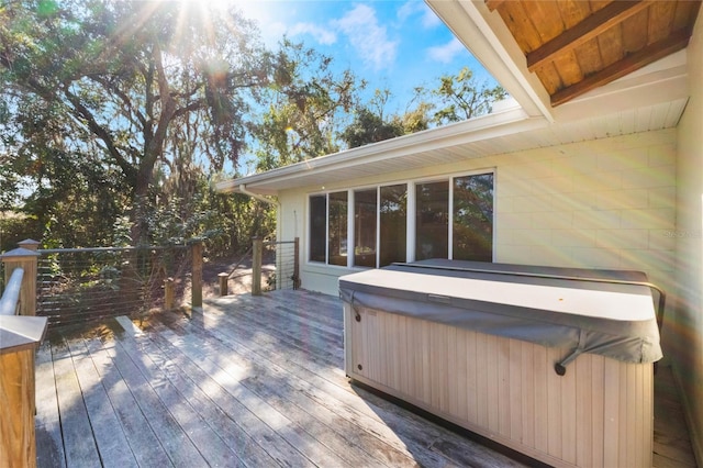 wooden deck featuring a hot tub