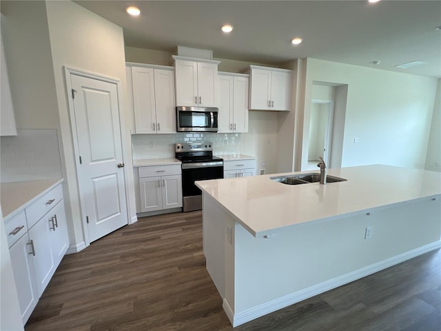 kitchen with sink, white cabinetry, an island with sink, and appliances with stainless steel finishes