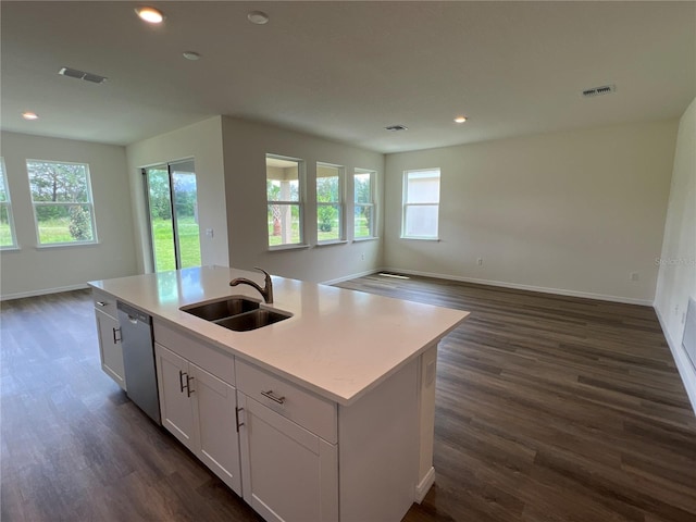 kitchen featuring an island with sink, dark hardwood / wood-style flooring, sink, white cabinetry, and stainless steel dishwasher