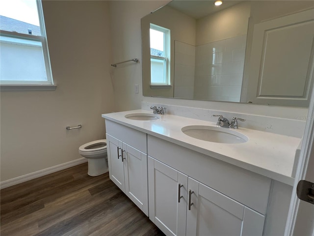 bathroom featuring vanity, hardwood / wood-style flooring, and toilet