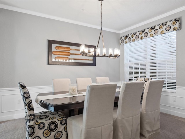 dining room with ornamental molding, carpet floors, and a notable chandelier