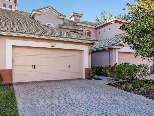 mediterranean / spanish house featuring a garage