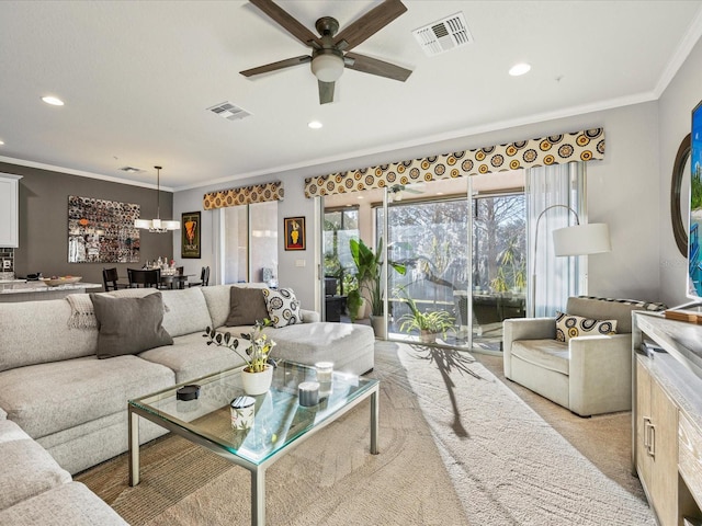 carpeted living room featuring crown molding and ceiling fan with notable chandelier