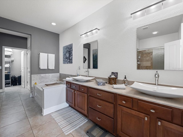 bathroom with tile patterned flooring, vanity, and independent shower and bath