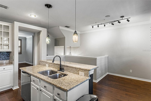 kitchen with dishwasher, sink, pendant lighting, and white cabinets