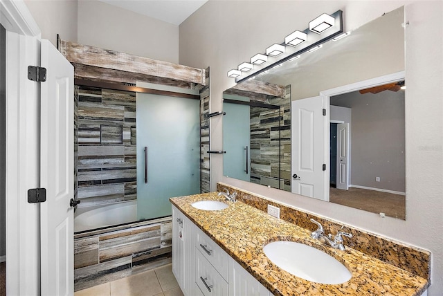 bathroom with bath / shower combo with glass door, tile patterned floors, and vanity