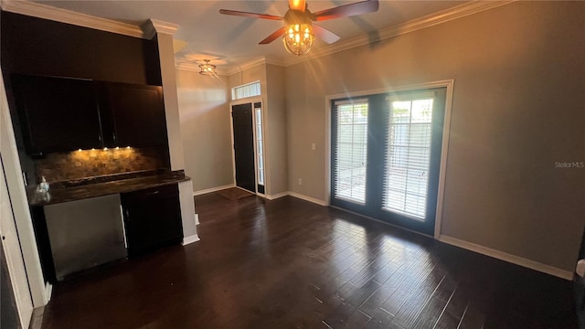 interior space with dark hardwood / wood-style flooring, crown molding, french doors, and ceiling fan