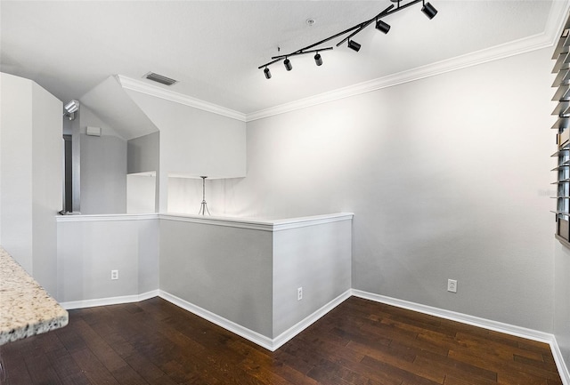 hall featuring ornamental molding, rail lighting, and dark hardwood / wood-style floors