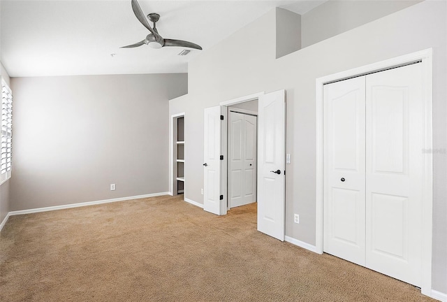 unfurnished bedroom featuring high vaulted ceiling, light colored carpet, and ceiling fan