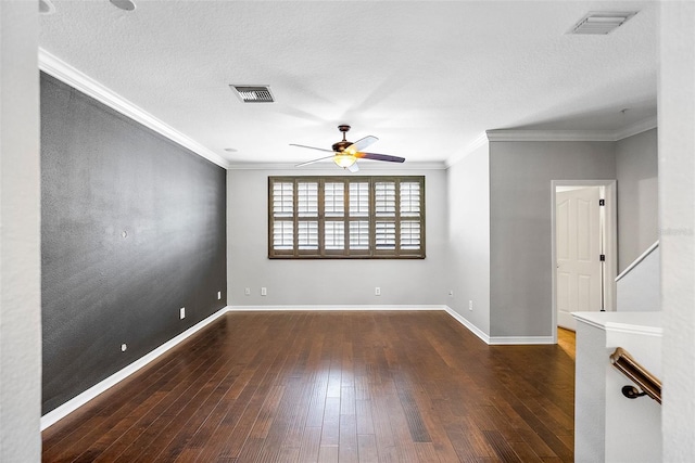 spare room featuring crown molding, ceiling fan, dark hardwood / wood-style floors, and a textured ceiling