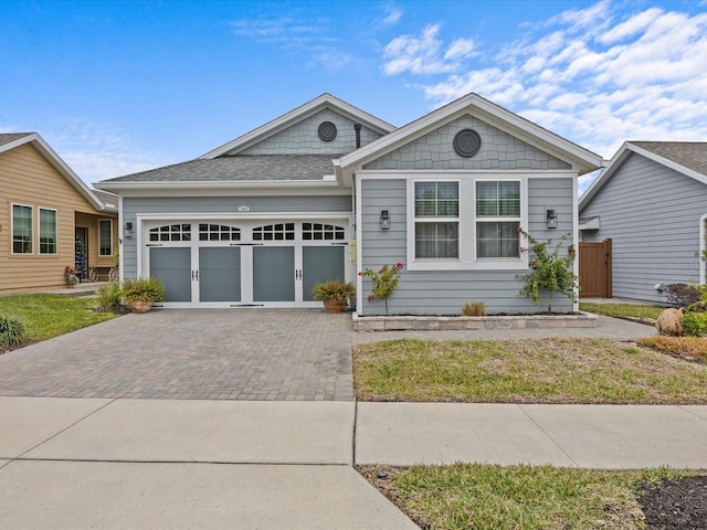 view of front of house with a front lawn and a garage