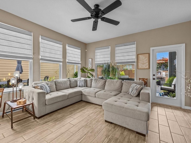 living room with light wood-type flooring and ceiling fan