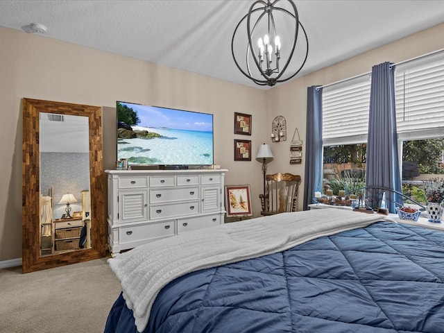 carpeted bedroom with a textured ceiling and a notable chandelier