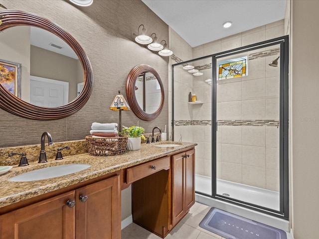 bathroom featuring tile patterned flooring, an enclosed shower, and vanity