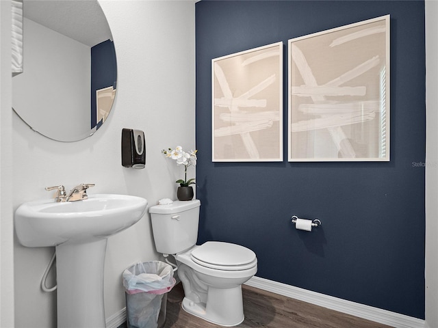 bathroom with sink, hardwood / wood-style floors, and toilet