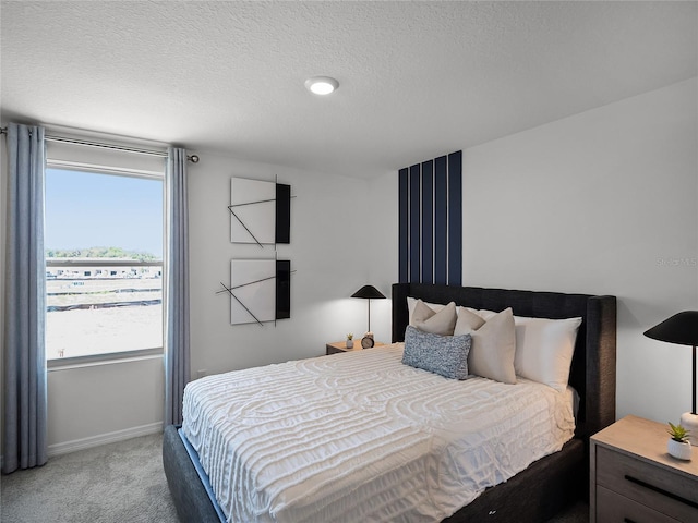 carpeted bedroom featuring a textured ceiling