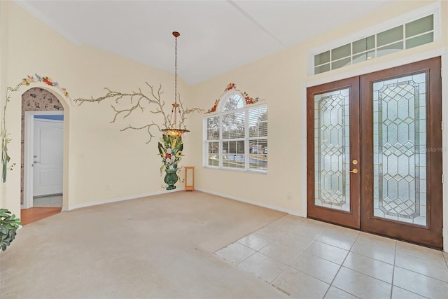 entrance foyer with light colored carpet and french doors