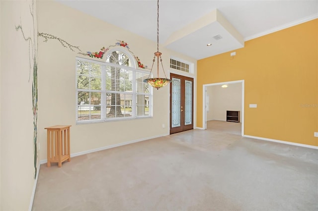 interior space featuring ornamental molding, light colored carpet, and french doors