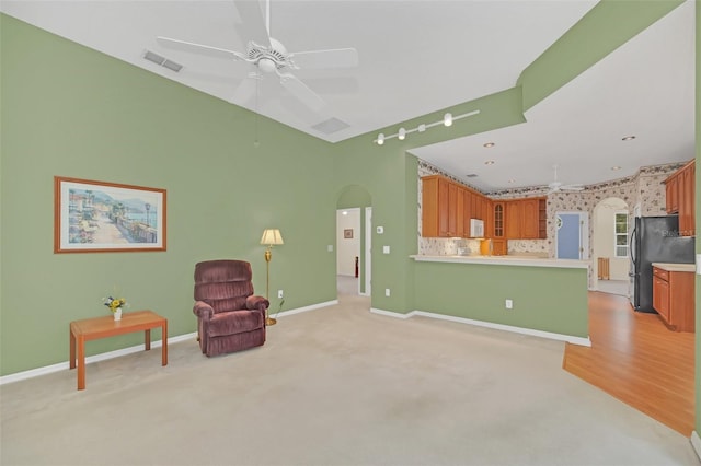 living area featuring ceiling fan and light colored carpet