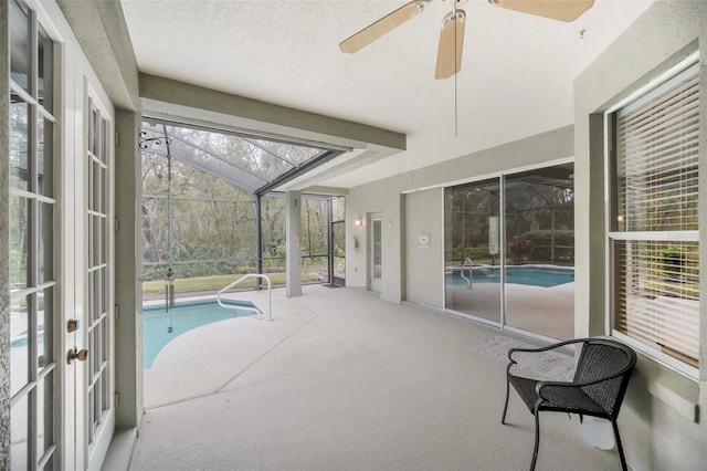 view of swimming pool featuring french doors, a lanai, and a patio area