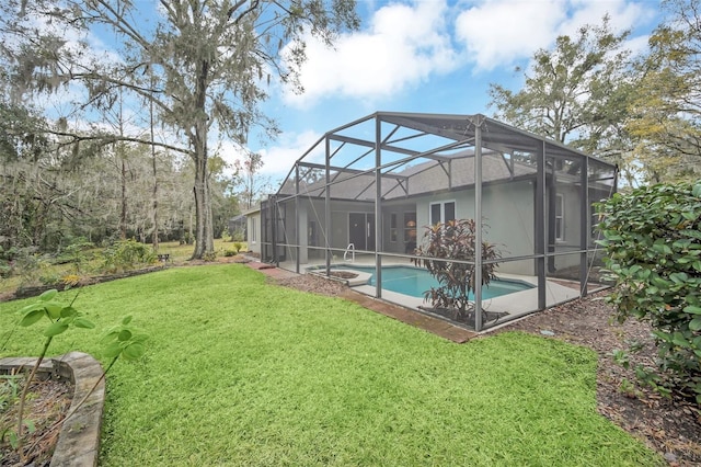 view of yard featuring glass enclosure and a pool with hot tub